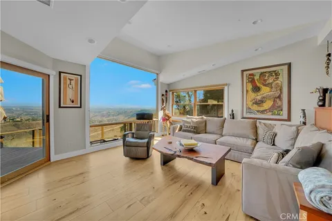 a living room with furniture and floor to ceiling window