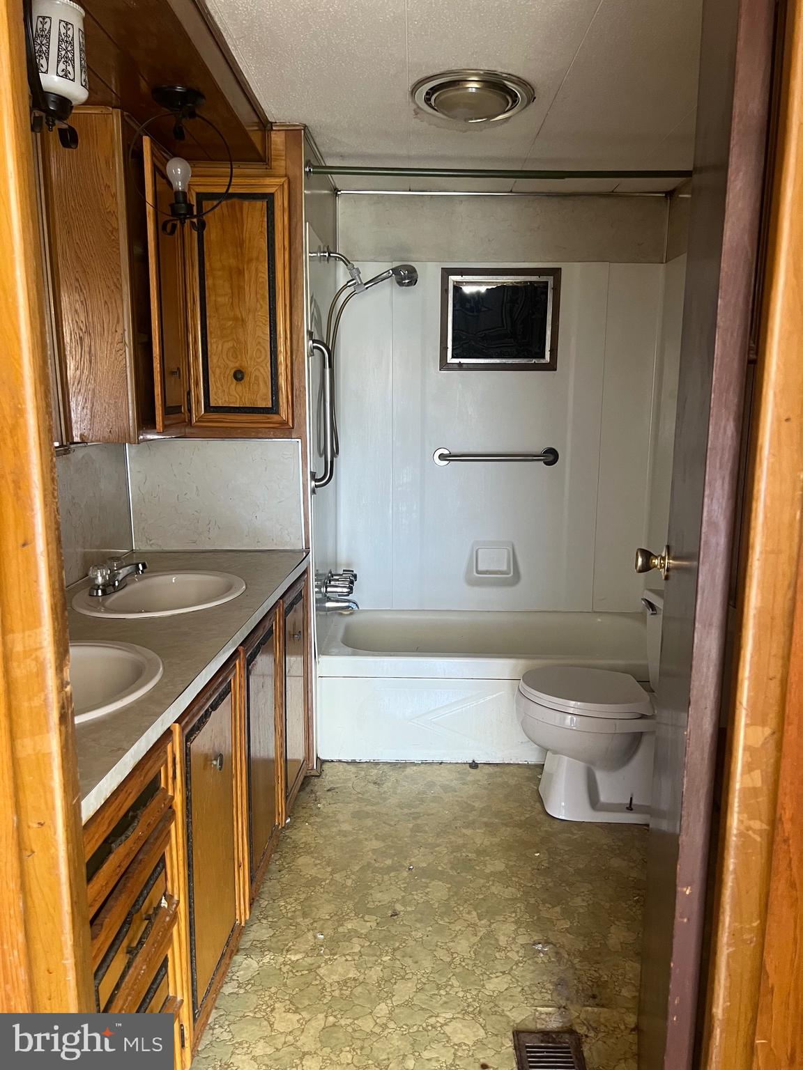 1302 Gibson Road, Unit 152 Bensalem, PA 19020 - Photo 9 of 17 a bathroom with a sink a toilet and shower