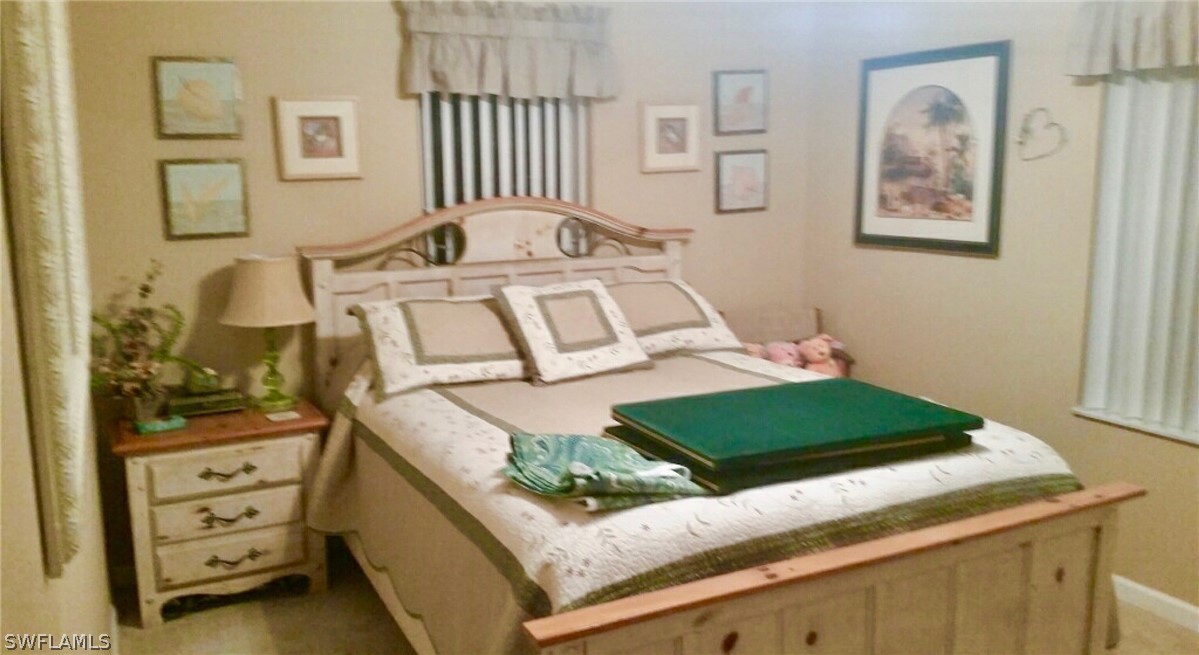 15550 Burnt Store Road, Unit 13 Punta Gorda, FL 33955 - Photo 11 of 30 a bedroom with a bed and a window