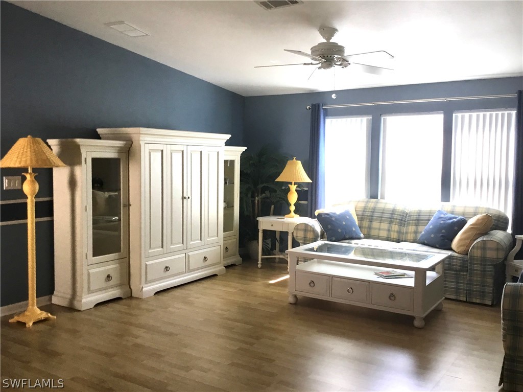 15550 Burnt Store Road, Unit 13 Punta Gorda, FL 33955 - Photo 12 of 30 a living room with furniture and a chandelier