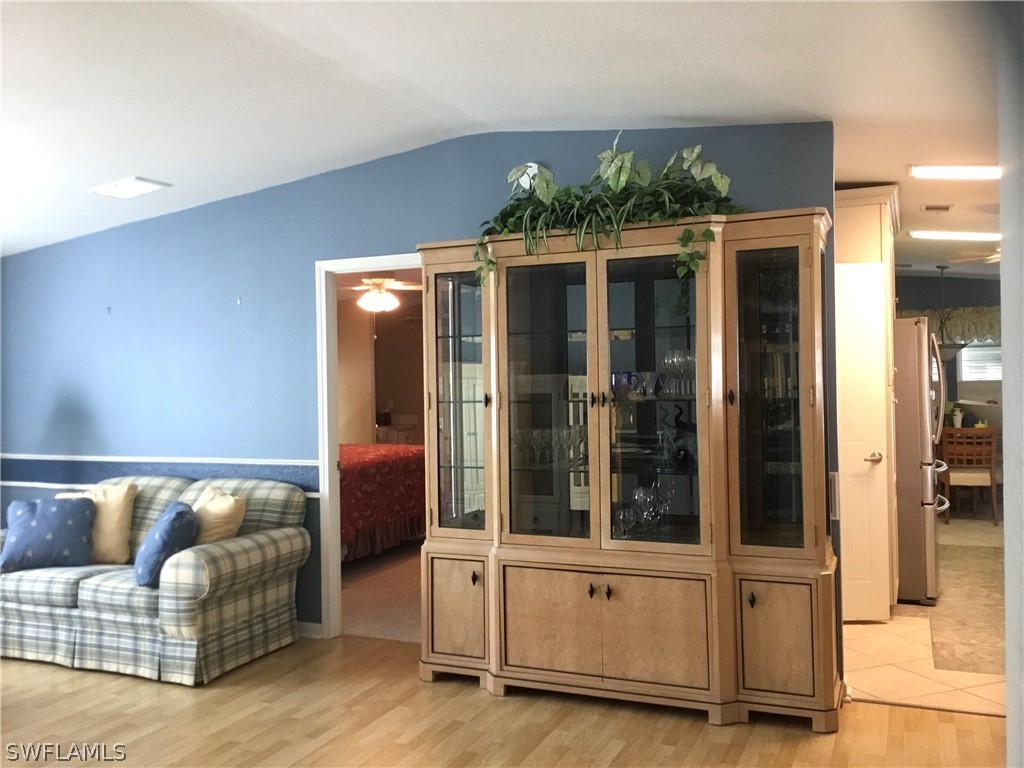 15550 Burnt Store Road, Unit 13 Punta Gorda, FL 33955 - Photo 14 of 30 a living room with furniture and a chandelier