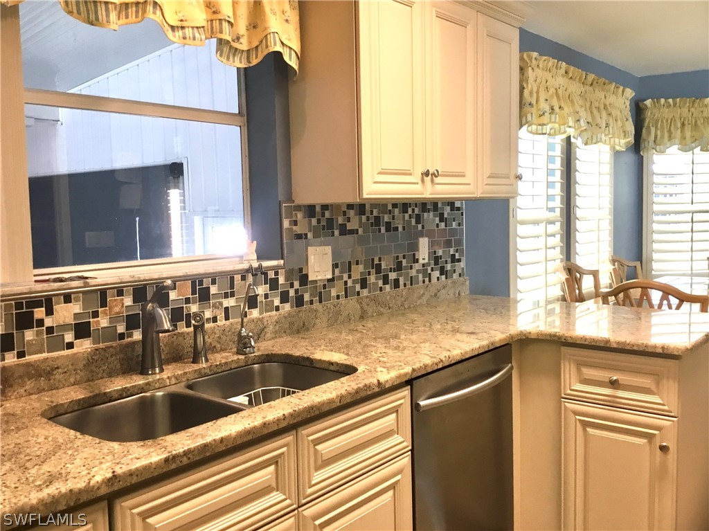 15550 Burnt Store Road, Unit 13 Punta Gorda, FL 33955 - Photo 18 of 30 a kitchen with granite countertop a sink and a stove