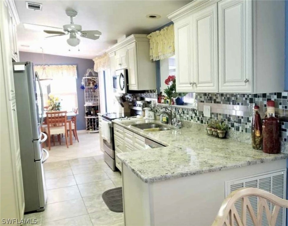 15550 Burnt Store Road, Unit 13 Punta Gorda, FL 33955 - Photo 20 of 30 a kitchen with sink refrigerator and cabinets