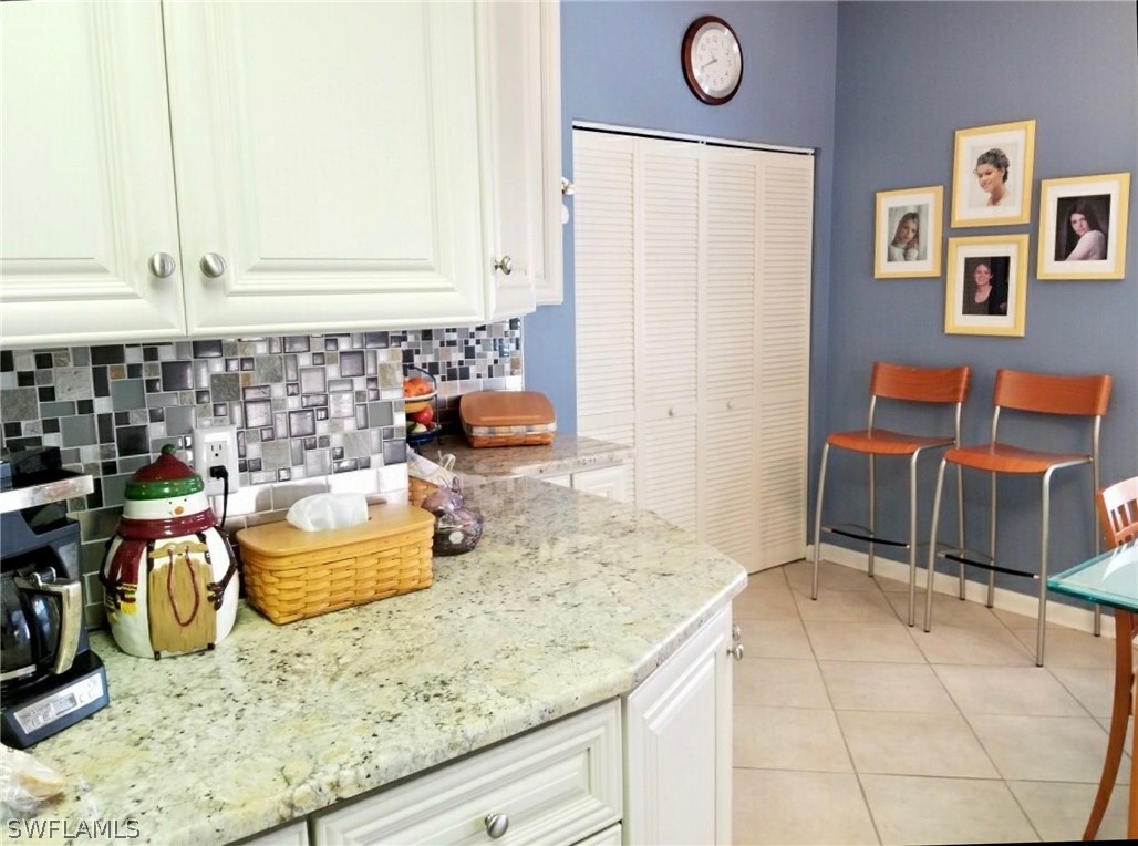 15550 Burnt Store Road, Unit 13 Punta Gorda, FL 33955 - Photo 21 of 30 a kitchen with blue cabinets a sink and a stove