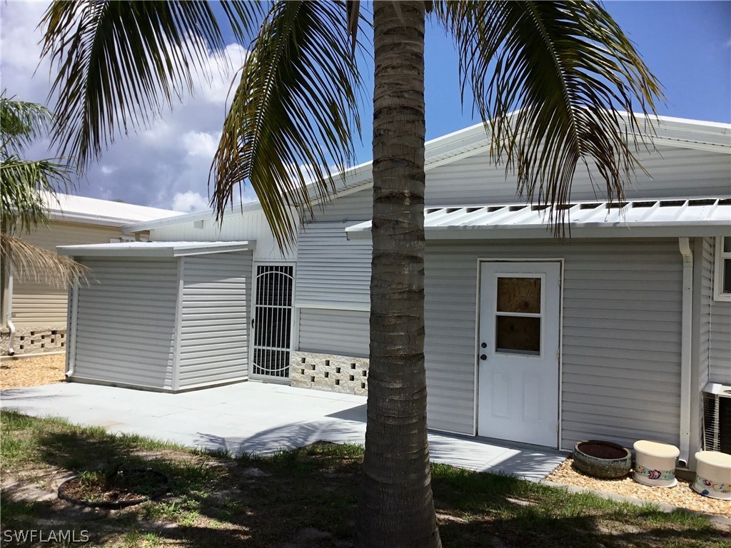 15550 Burnt Store Road, Unit 13 Punta Gorda, FL 33955 - Photo 26 of 30 a view of a house with a yard