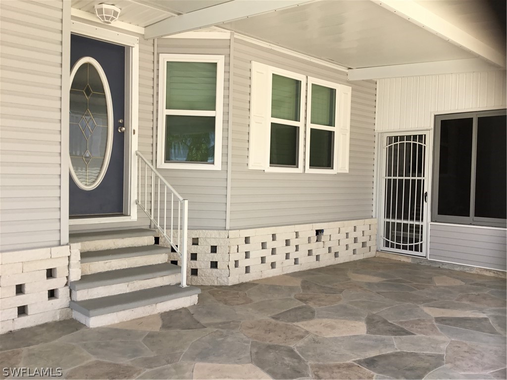 15550 Burnt Store Road, Unit 13 Punta Gorda, FL 33955 - Photo 3 of 30 a front view of a house with entryway