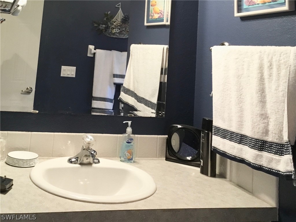 15550 Burnt Store Road, Unit 13 Punta Gorda, FL 33955 - Photo 10 of 30 a bathroom with a sink and a mirror