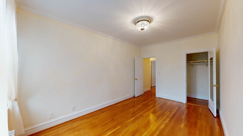 311 Tappan Street, Unit 3 Brookline, MA 02445 - Photo 33 of 35 a view of empty room with wooden floor