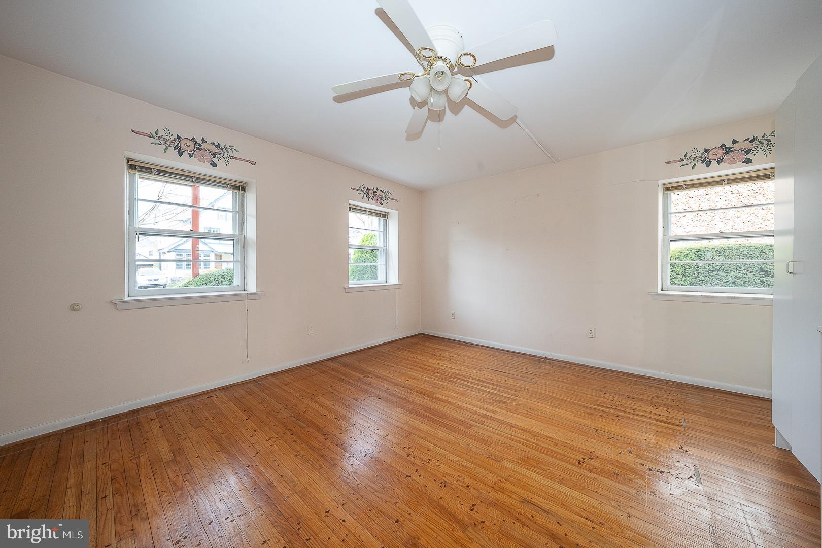 11 Tenby Road Havertown, PA 19083 - Photo 14 of 57 a view of an empty room with wooden floor and a window