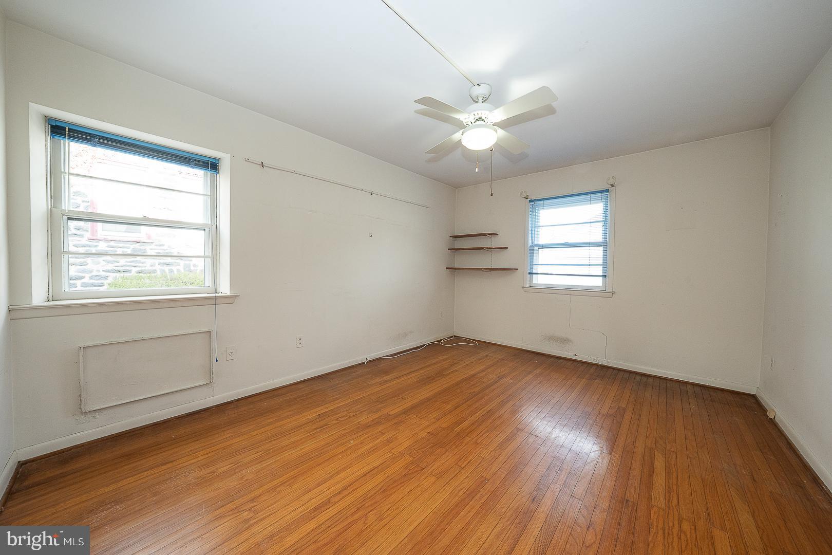 11 Tenby Road Havertown, PA 19083 - Photo 19 of 57 a view of an empty room with wooden floor and a window