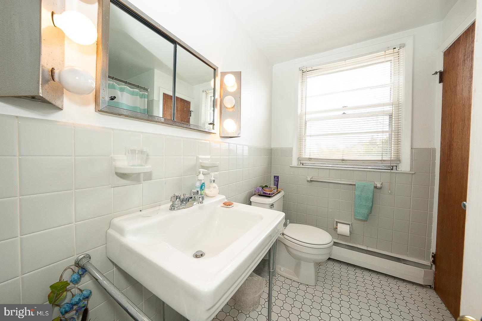 11 Tenby Road Havertown, PA 19083 - Photo 37 of 57 a bathroom with a sink a toilet and mirror