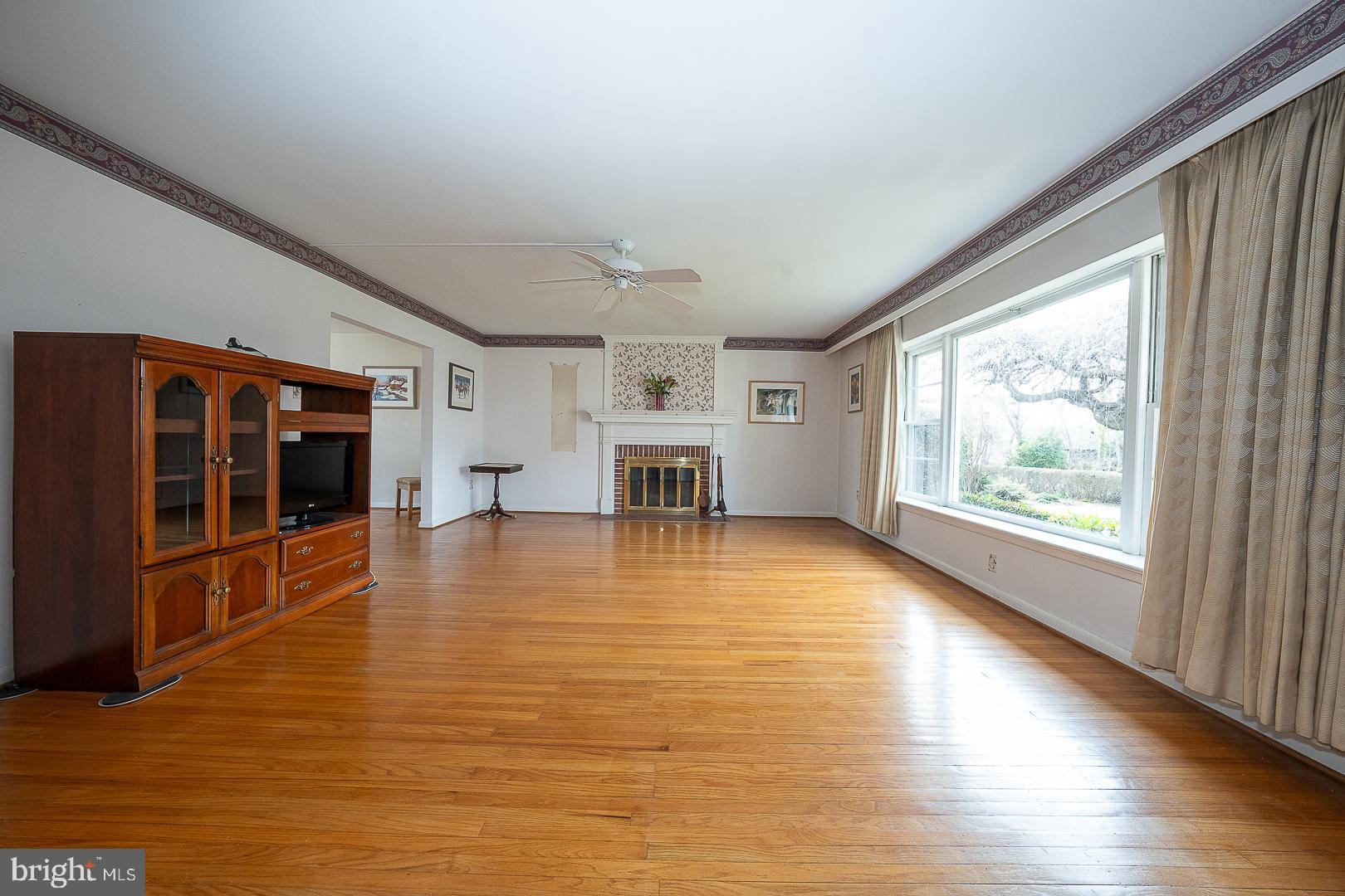 11 Tenby Road Havertown, PA 19083 - Photo 6 of 57 a view of empty room with wooden floor and fireplace
