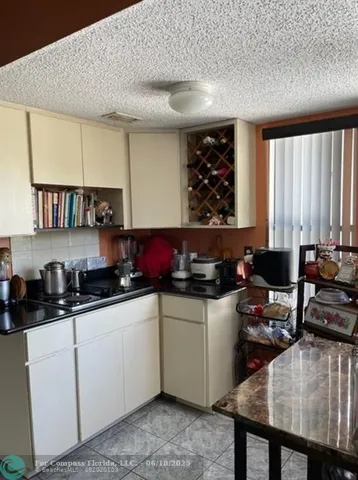 a kitchen with a sink a stove and cabinets