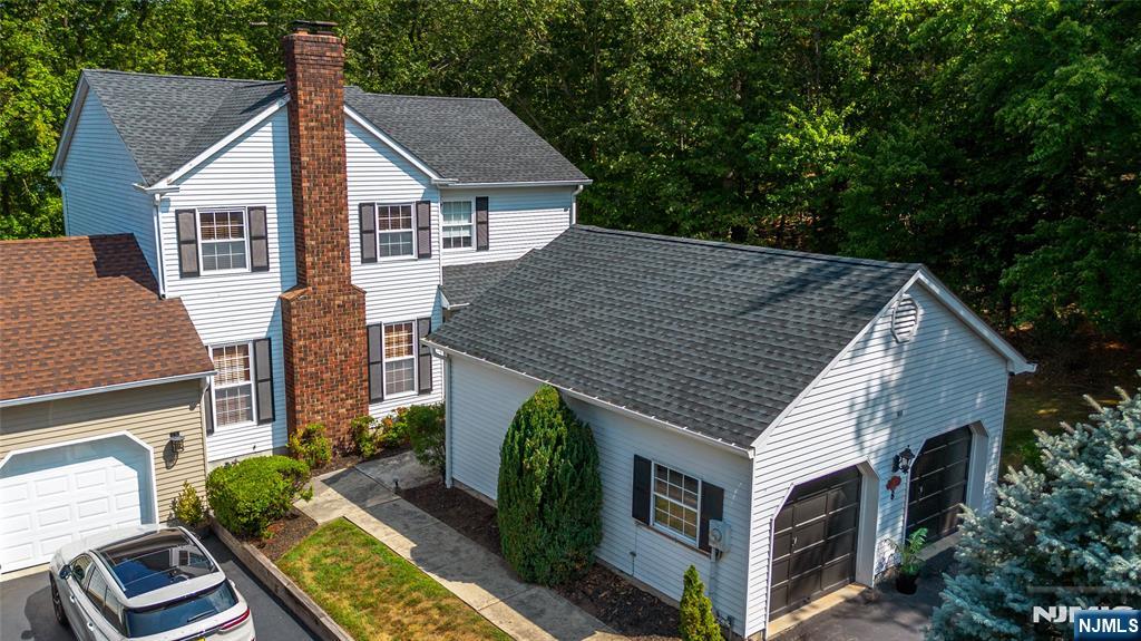 a aerial view of a house next to a yard