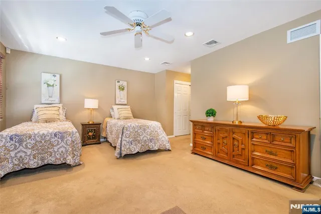 a bedroom with two beds and painting on the wall