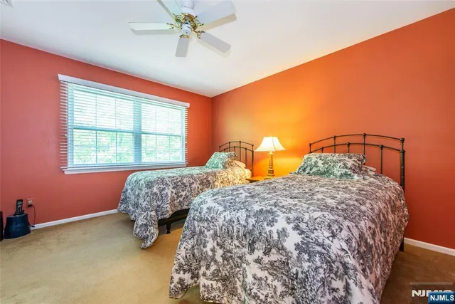 a bedroom with two beds and a window