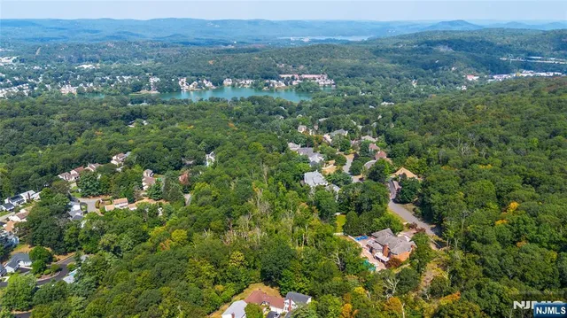 an aerial view of house with yard and outdoor seating
