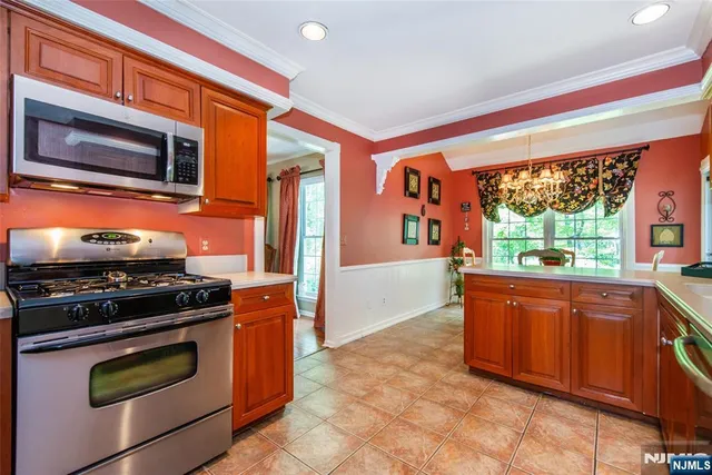 a kitchen with stainless steel appliances granite countertop a stove and a microwave