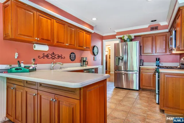 a kitchen with stainless steel appliances granite countertop a refrigerator and a sink
