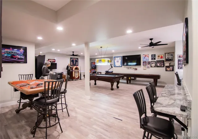 a dining room with furniture and wooden floor