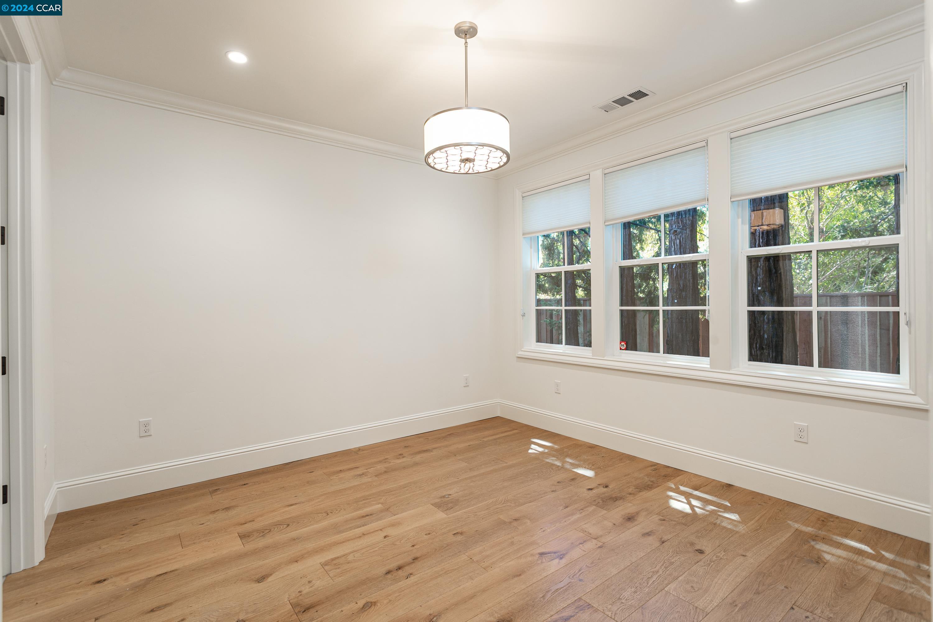 962 Reliez Station Lane Lafayette, CA 94549 - Photo 15 of 25 a view of an empty room with wooden floor and a window