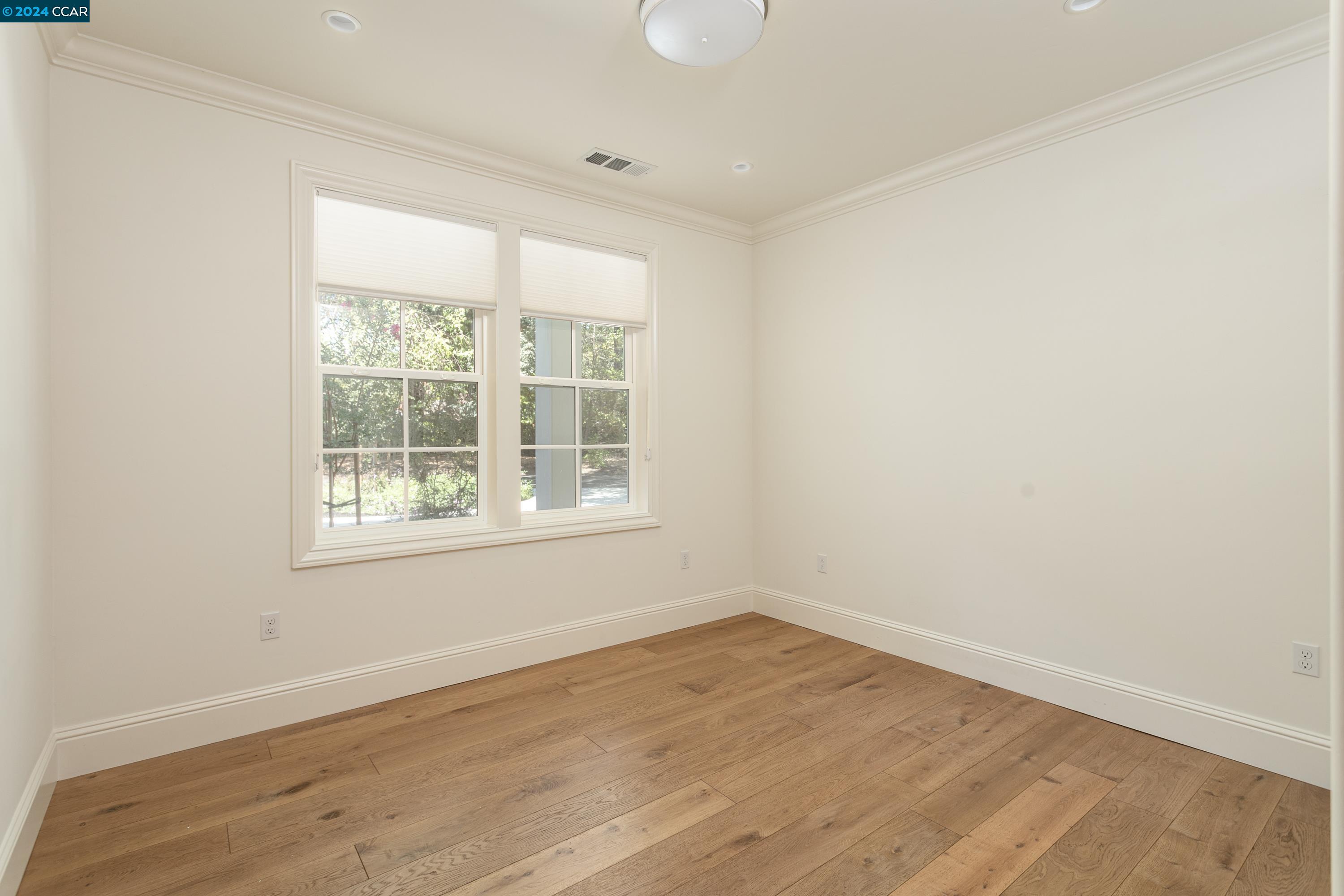 962 Reliez Station Lane Lafayette, CA 94549 - Photo 18 of 25 an empty room with wooden floor and windows