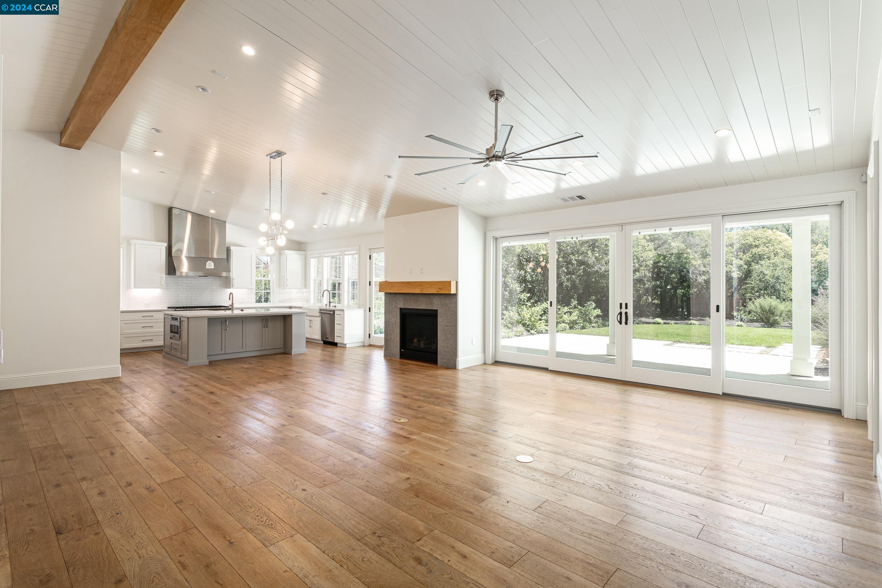 962 Reliez Station Lane Lafayette, CA 94549 - Photo 2 of 25 a view of an empty room with wooden floor and a fireplace