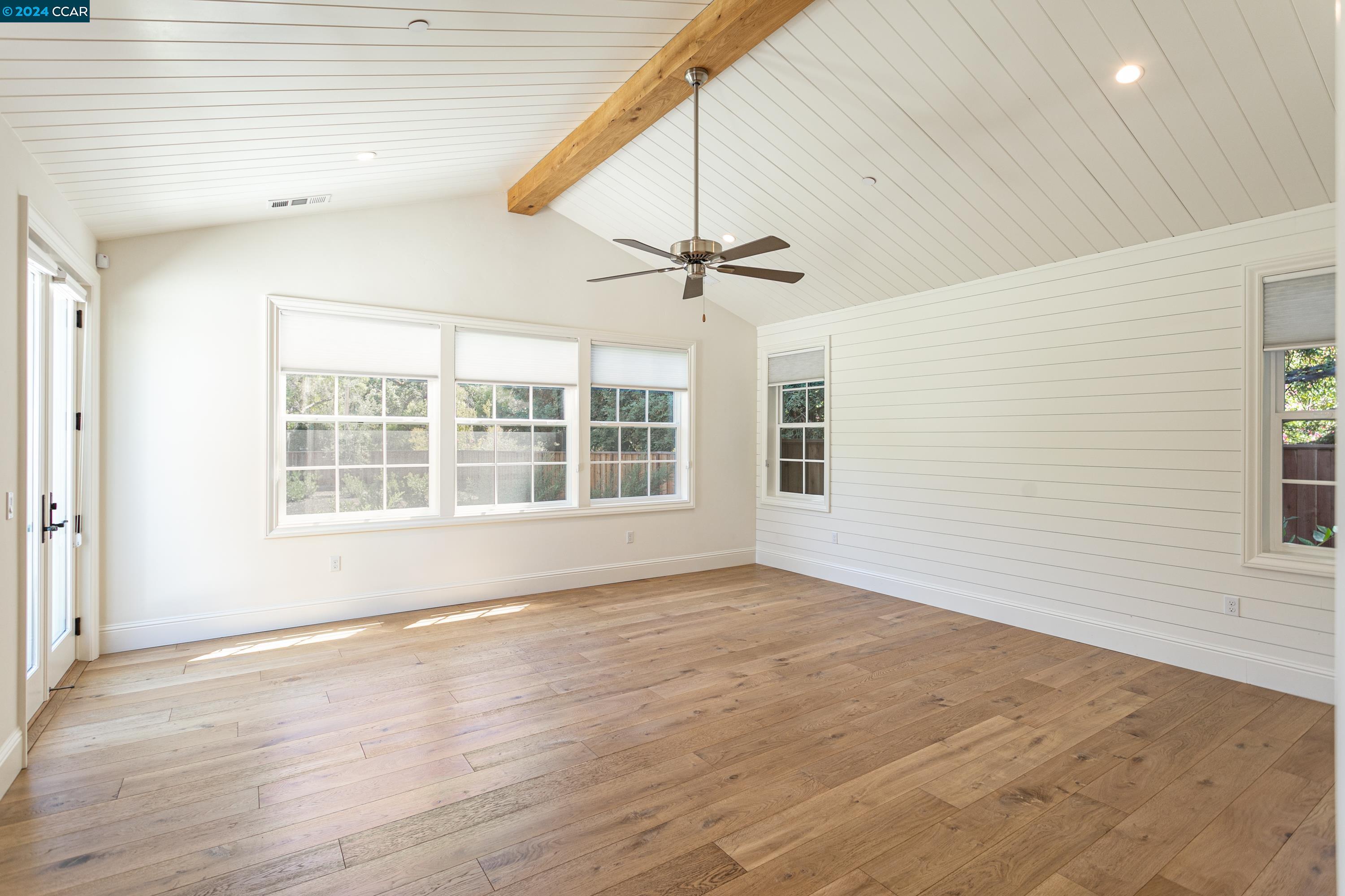 962 Reliez Station Lane Lafayette, CA 94549 - Photo 9 of 25 a view of an empty room with a window and wooden floor