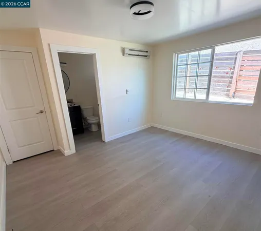 an empty room with windows and closet