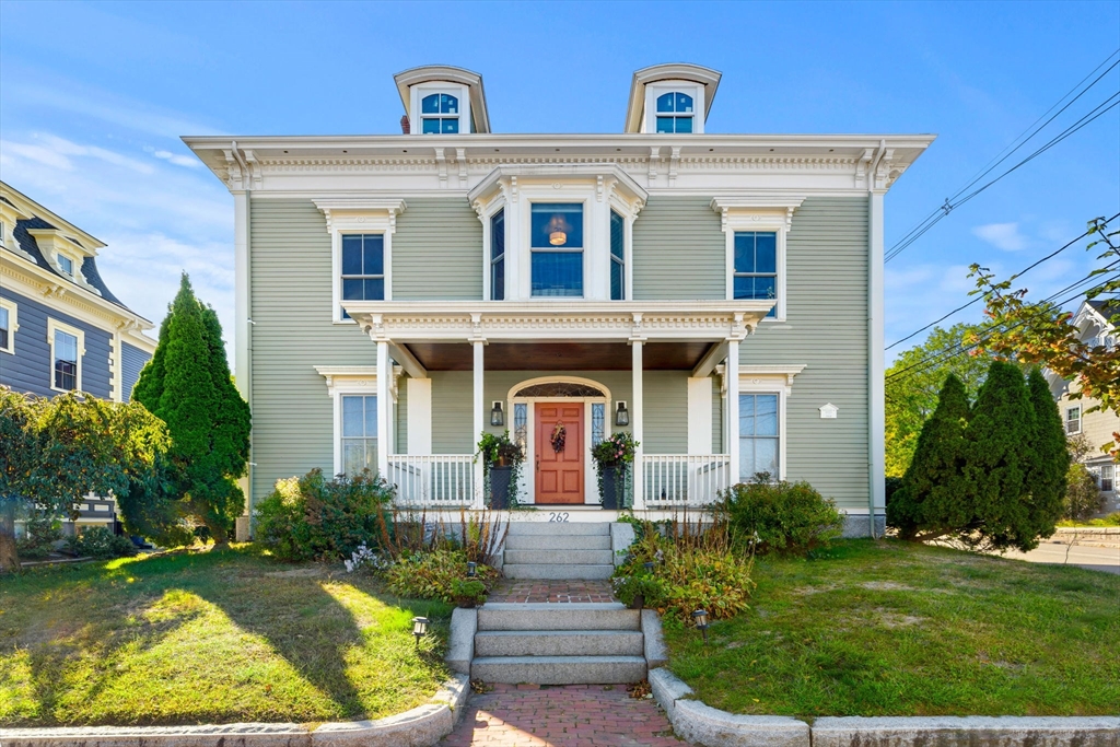 a front view of a house with garden