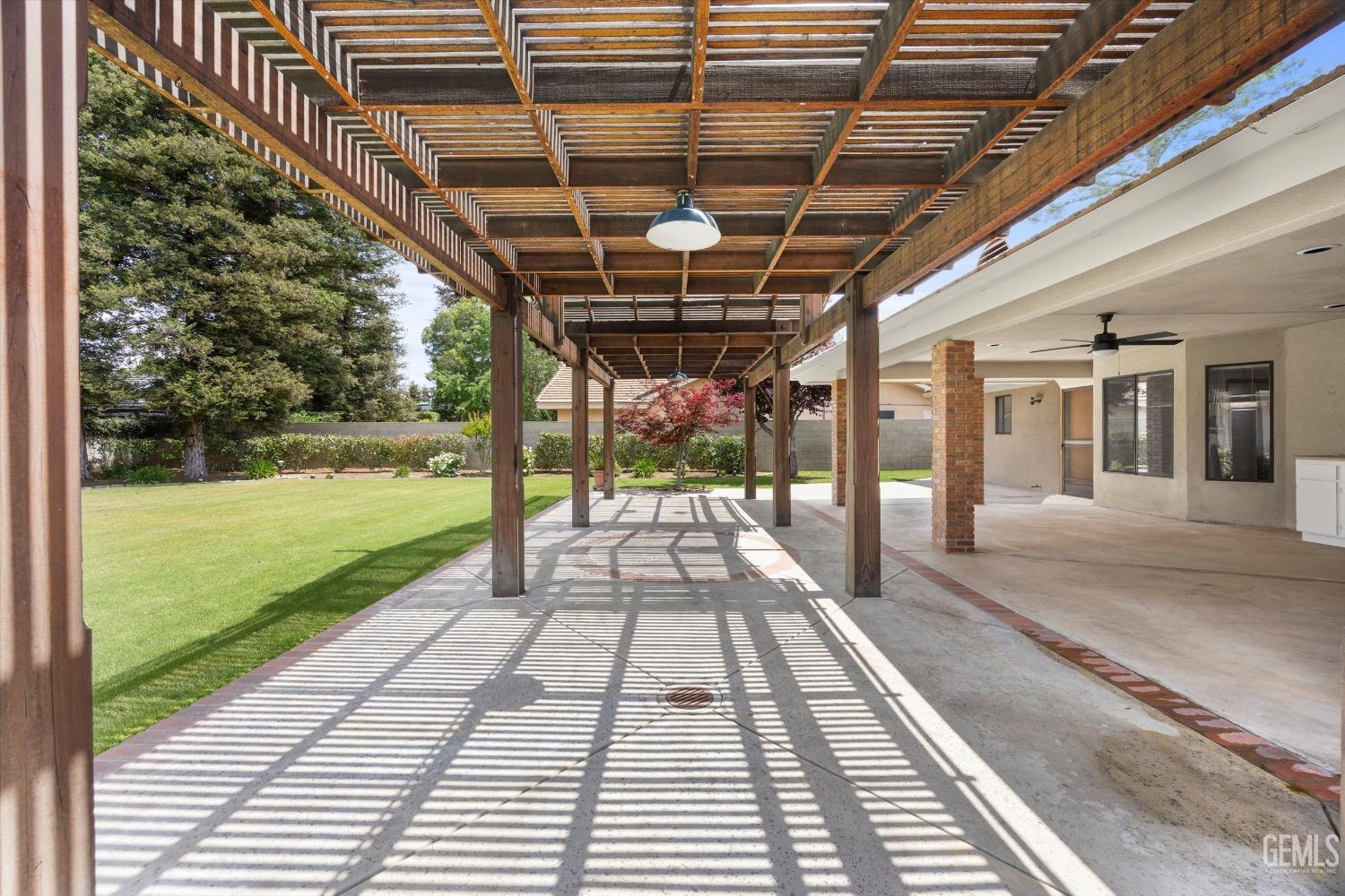 Undisclosed Address Bakersfield, CA 93309 - Photo 11 of 15 a view of a porch with wooden floor and yard in the back