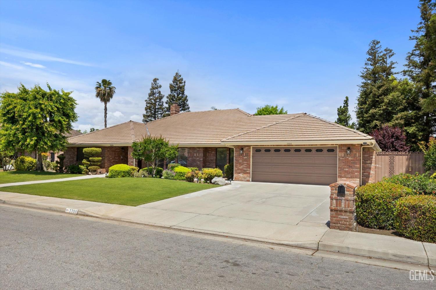 Undisclosed Address Bakersfield, CA 93309 - Photo 2 of 15 a front view of house with yard and trees