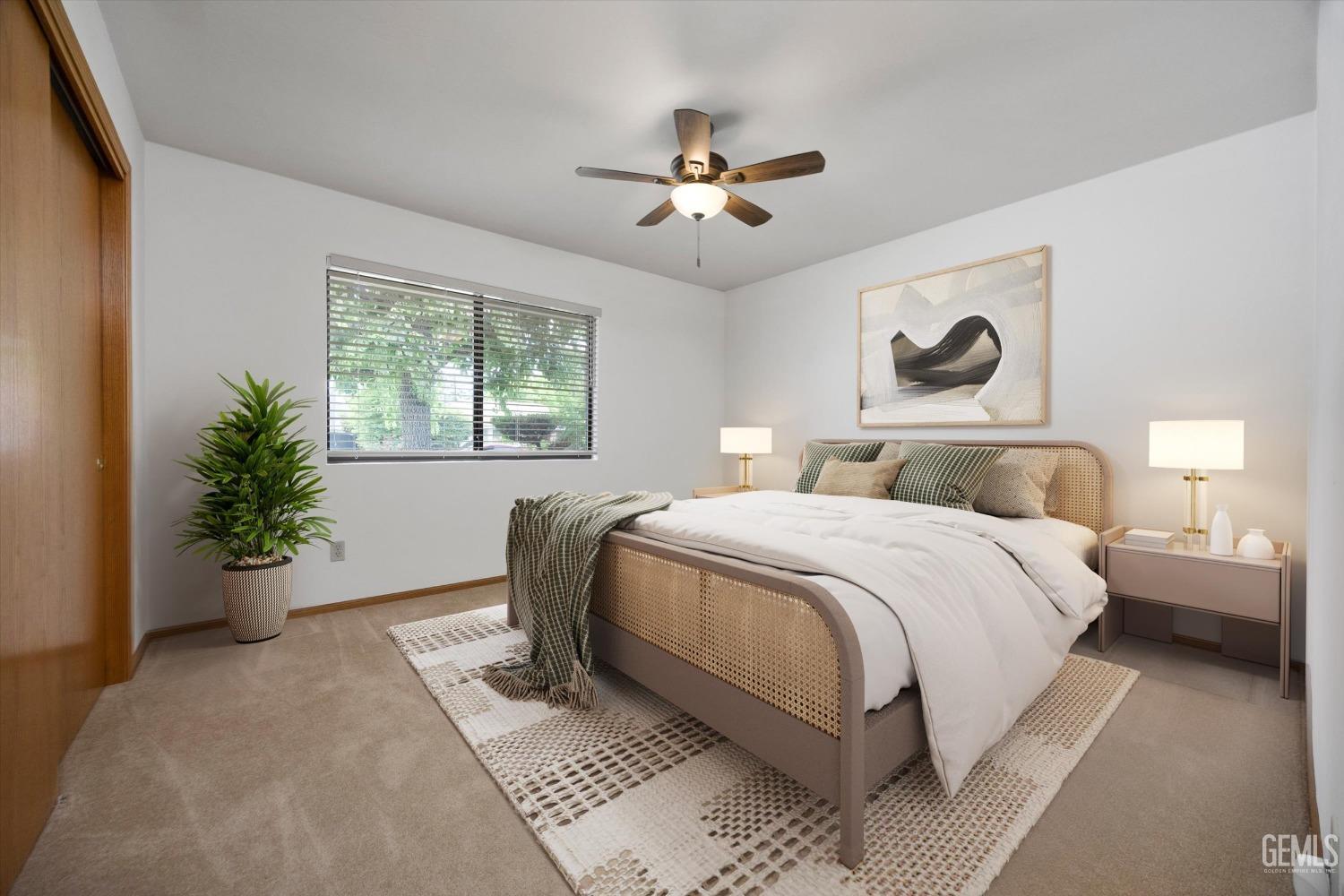 Undisclosed Address Bakersfield, CA 93309 - Photo 6 of 15 a bedroom with a large bed and a potted plant