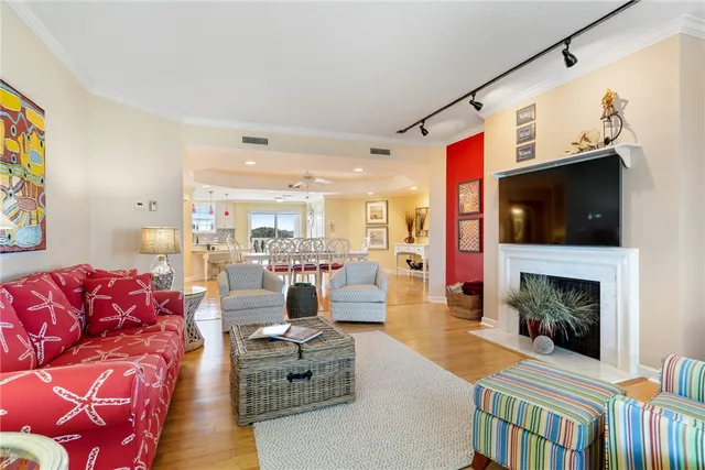 a living room with furniture a flat screen tv and a fireplace