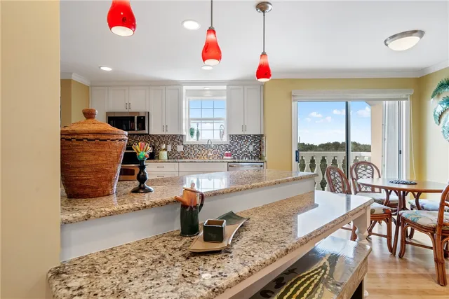 a kitchen with sink refrigerator and cabinets