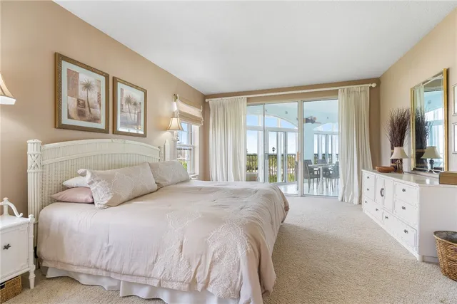 a bedroom with a large bed and a large window