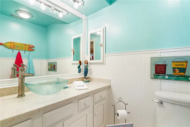 a bathroom with a sink vanity and a mirror