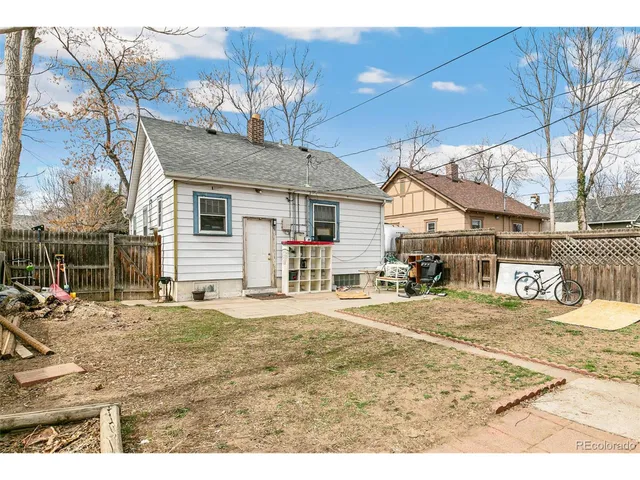 a view of a white house with a yard covered in snow