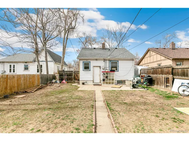a view of a white house with a patio