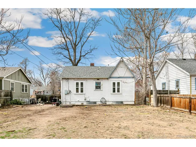 a large house with a large tree in front of it