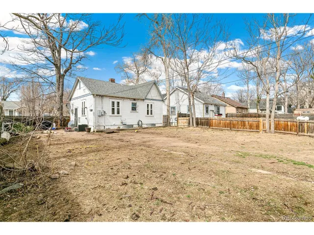 a view of a house with a yard covered in snow