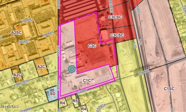 a bed with a white comforter and pillows