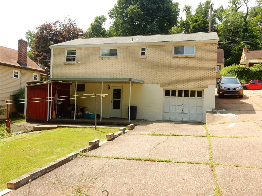 321 East Garden Road Pittsburgh, PA 15227 - Photo 3 of 20 A view of the back of the home, 1 car integral garage, covered patio and side yard.