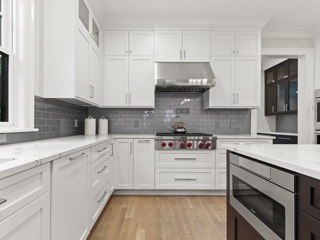 30 Columbine Road Newton, MA 02459 - Photo 12 of 35 a kitchen with stainless steel appliances granite countertop a stove a sink and white cabinets