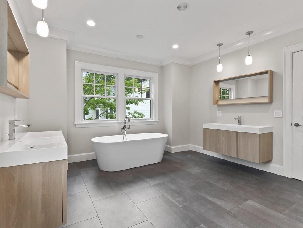 30 Columbine Road Newton, MA 02459 - Photo 21 of 35 a bathroom with a double vanity sink a mirror and a bathtub