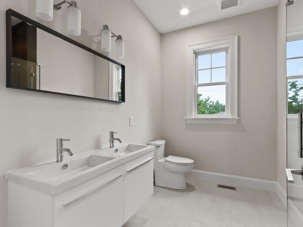 30 Columbine Road Newton, MA 02459 - Photo 24 of 35 a bathroom with a toilet sink and mirror