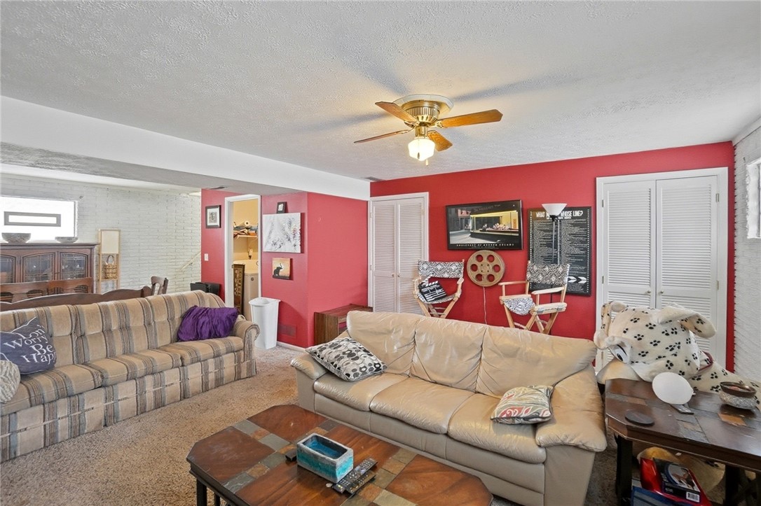 4780 Old Salem Road Englewood, OH 45322 - Photo 22 of 30 This living room features a classic ceiling fan, offering both comfort and timeless style.