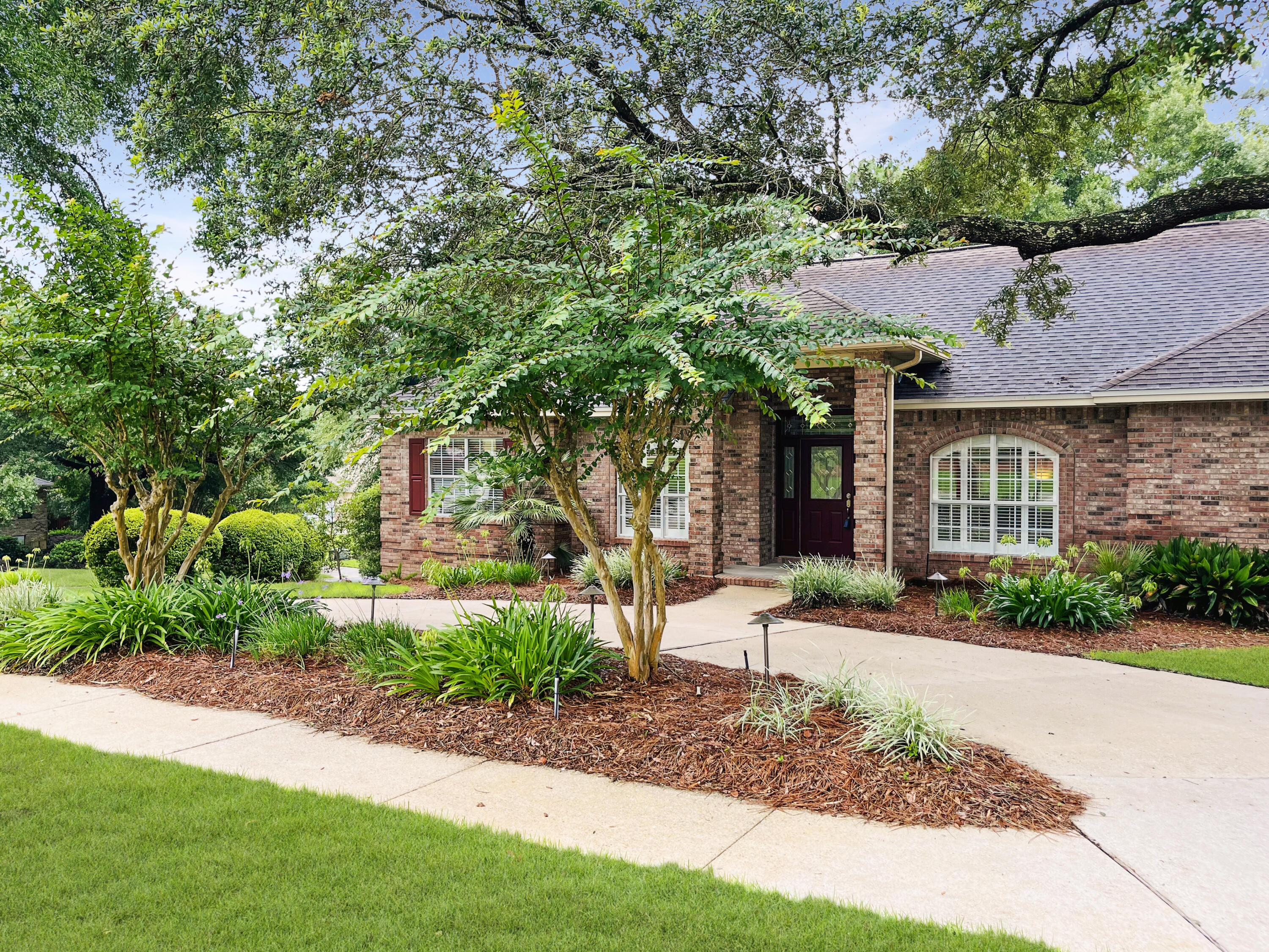 4100 Howard Drive Niceville, FL 32578 - Photo 2 of 133 a front view of a house with a yard and potted plants