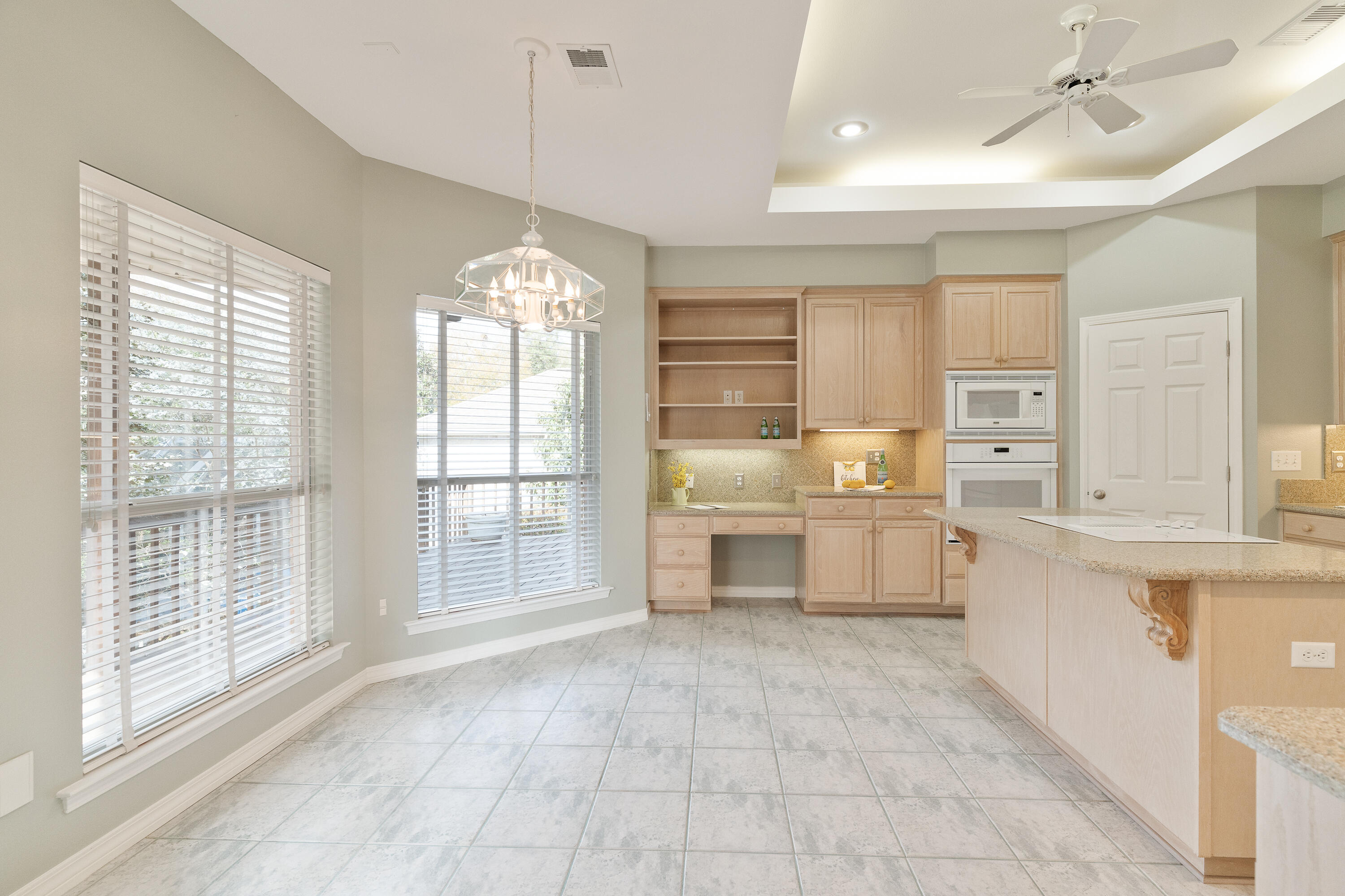 4100 Howard Drive Niceville, FL 32578 - Photo 38 of 133 a large white kitchen with cabinets a island a stove a sink and a large window