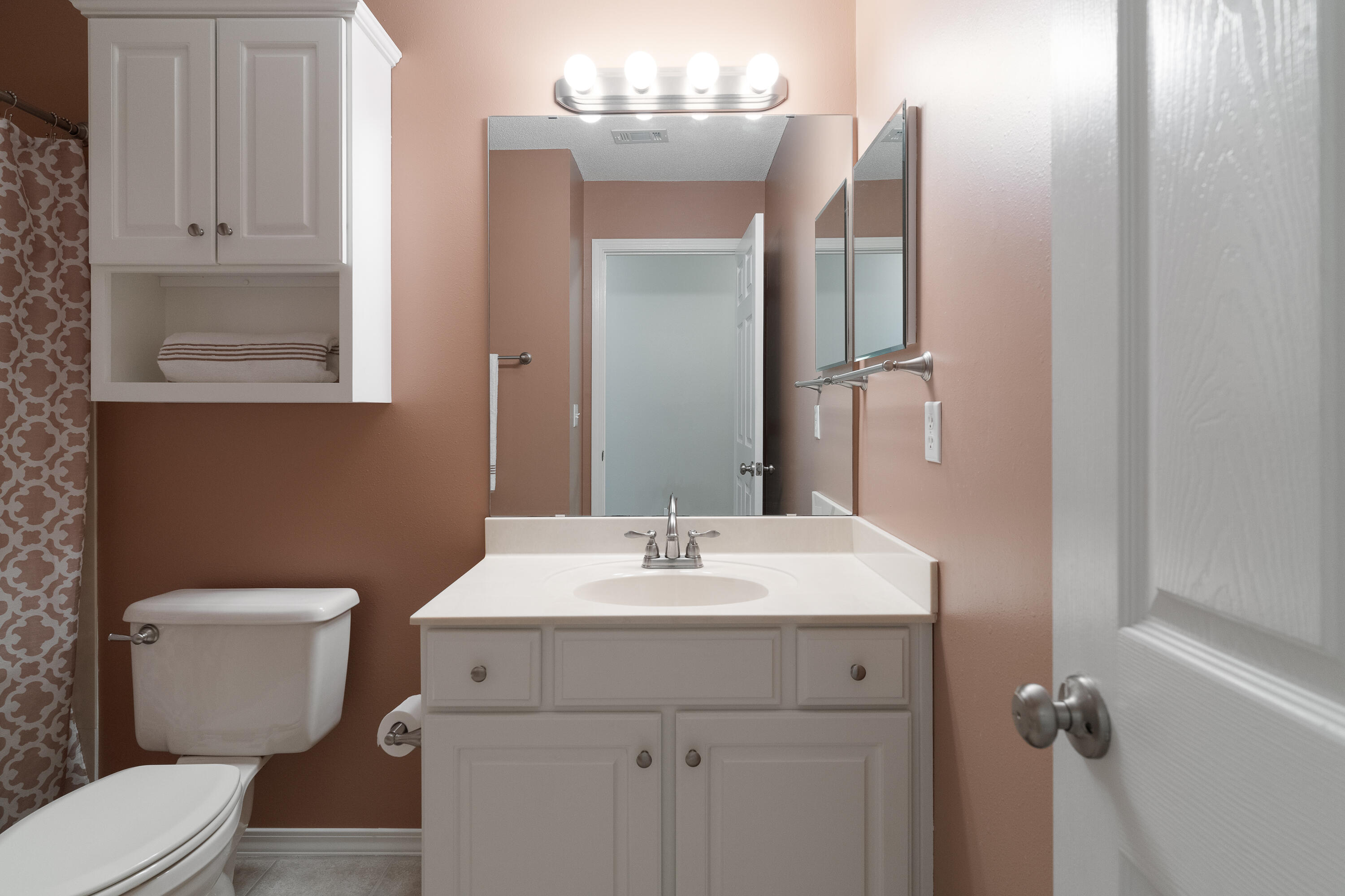 4100 Howard Drive Niceville, FL 32578 - Photo 75 of 133 a bathroom with a toilet sink and mirror
